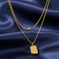 Gold necklace with a pendant on a blue satin background