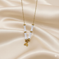 Necklace with white beads and gold accents on a beige satin background