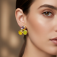 Close-up of a woman wearing colorful earrings with a blurred background